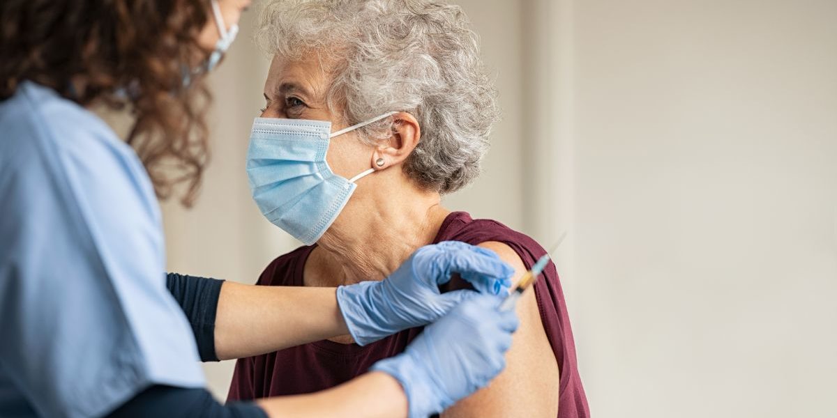 older woman receiving a vaccine