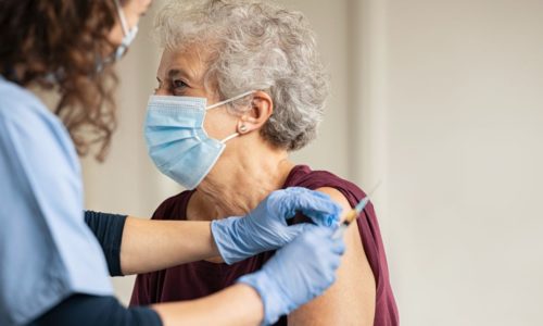 older woman receiving a vaccine